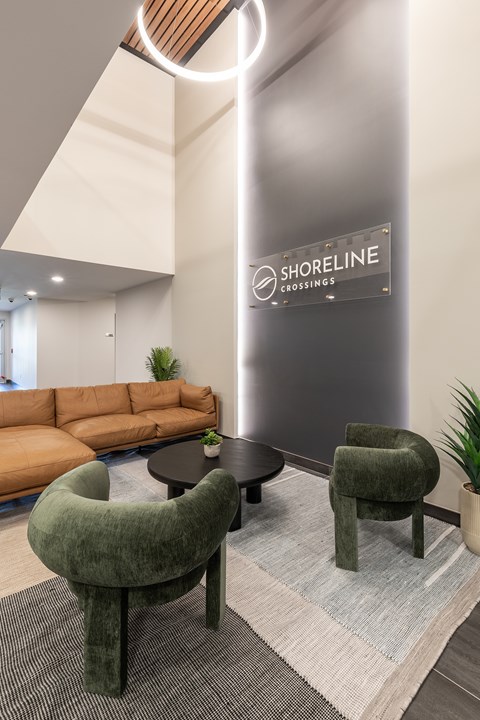 A modern waiting area with a green chair and a sign that says Shoreline Crossings.