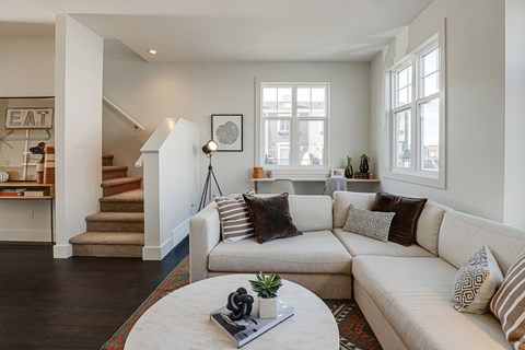A living room with a white couch and a coffee table.