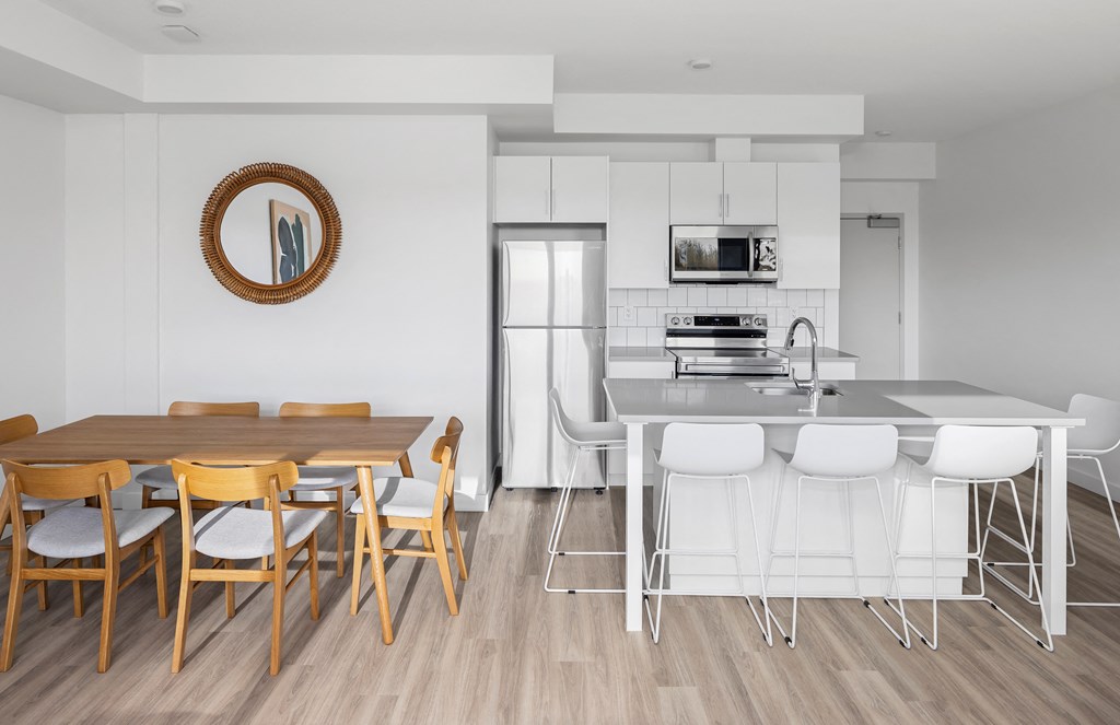 a kitchen and dining room with a table and chairs