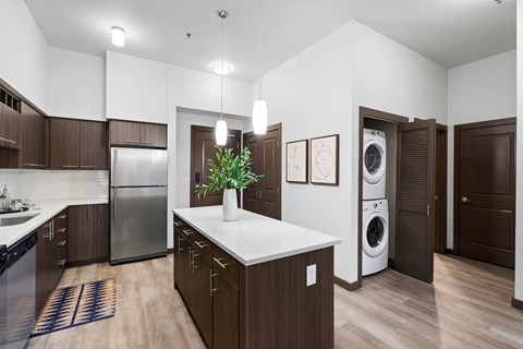 A modern kitchen with dark wood cabinets and a white countertop.