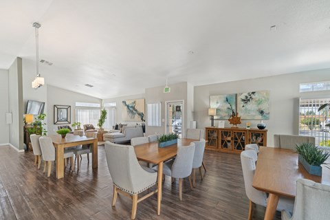 A dining room with a long table and chairs.