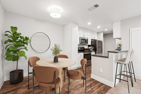 A modern dining room with a round table and chairs.