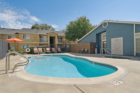 A small pool with a metal fence around it.
