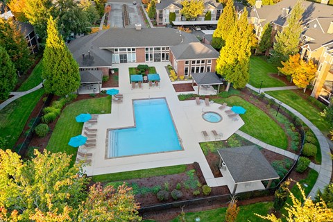 A large backyard with a pool and a deck.