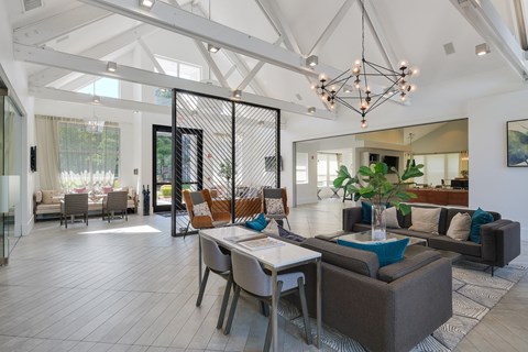 A modern living room with a dining table and chairs.