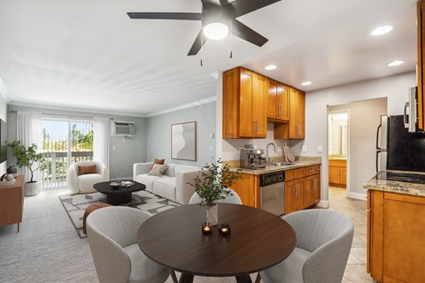 A modern living room with a dining table and chairs.