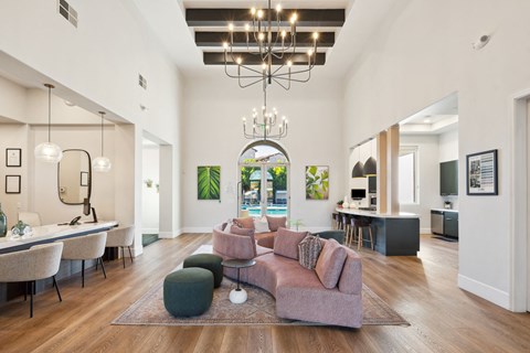 A living room with a large couch and a chandelier.