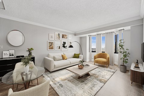 A modern living room with a glass table and a white sofa.