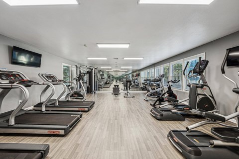 A gym with treadmills and exercise bikes.