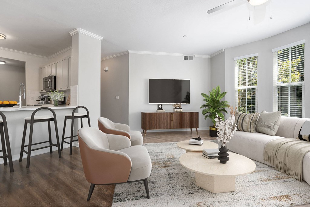 a living room with a white couch and a table with chairs