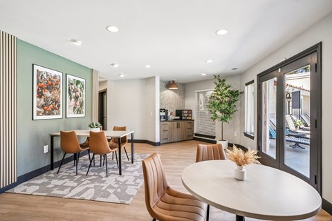 A dining room with a table and chairs.