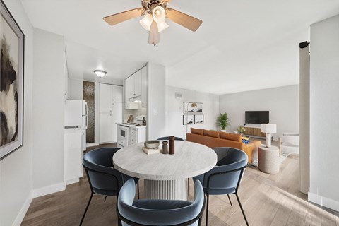 A modern dining room with a round table and chairs.