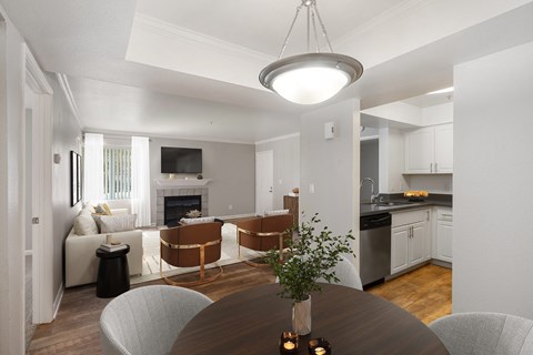 A modern kitchen with a dining table and chairs.