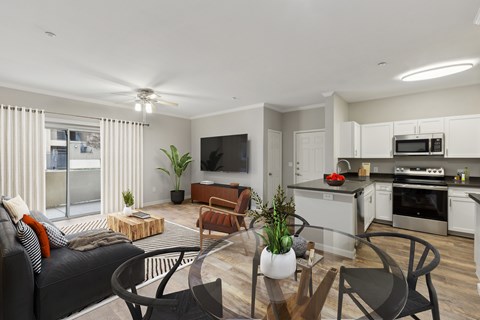 A modern living room with a black couch and a wooden coffee table.
