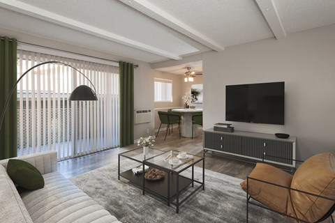 A modern living room with a glass coffee table and a flat screen TV.