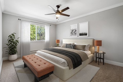 A bedroom with a large bed, a bench, and a potted plant.