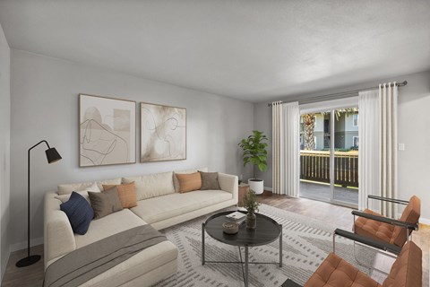 A living room with a white couch, a black coffee table, and a brown chair.