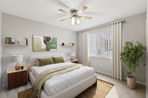 A bedroom with a bed, nightstand, and a plant.
