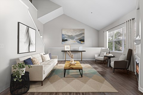 A living room with a couch, chairs, and a painting on the wall.