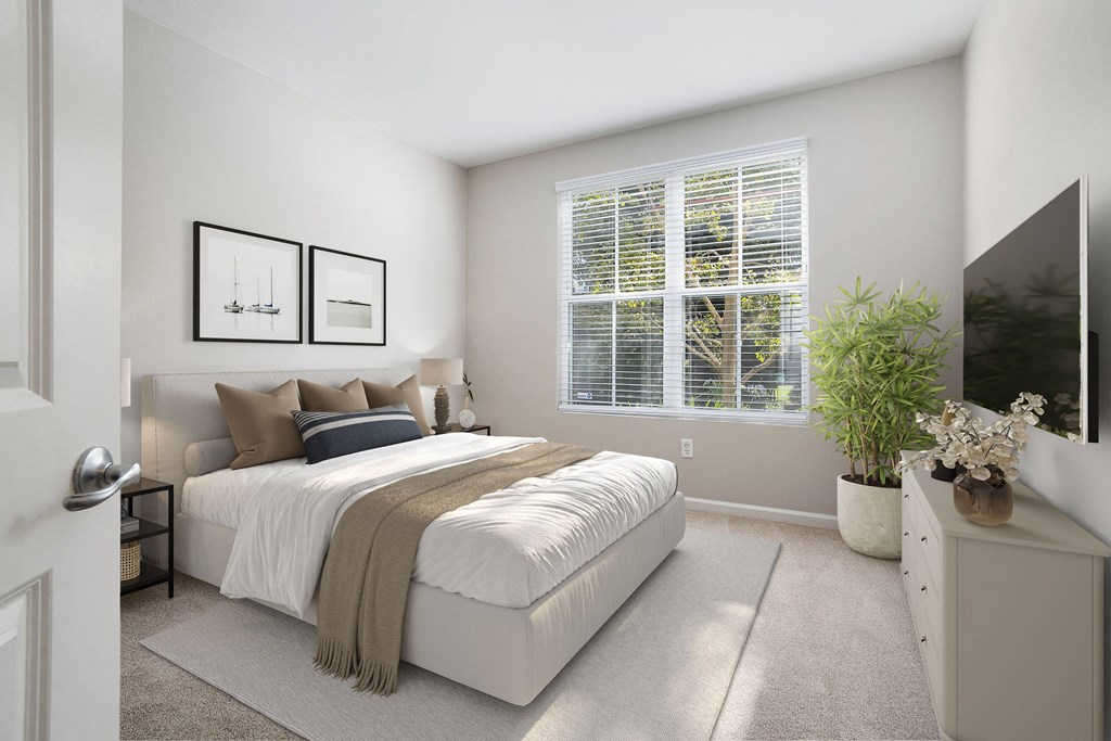 a bedroom with a bed and a large window