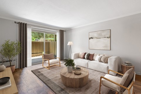 A living room with a couch, chair, and a table with a plant on it.