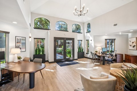 A modern living room with a large wooden table and comfortable seating.