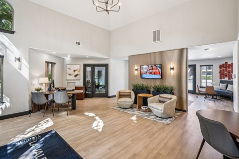 A living room with a wooden floor and a large window.
