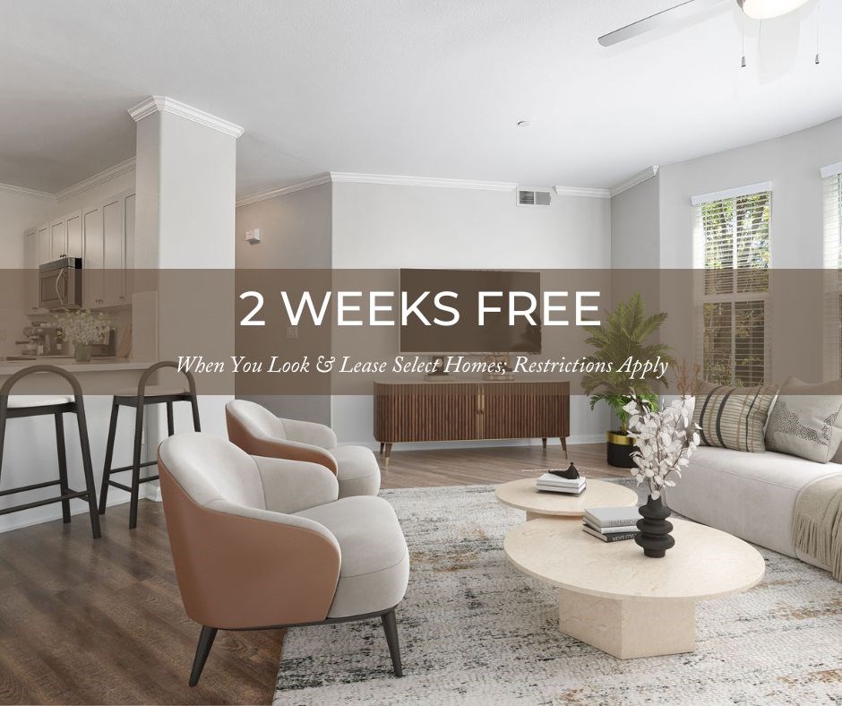 A modern living room with a sign offering 2 weeks free when you look and lease select homes.
