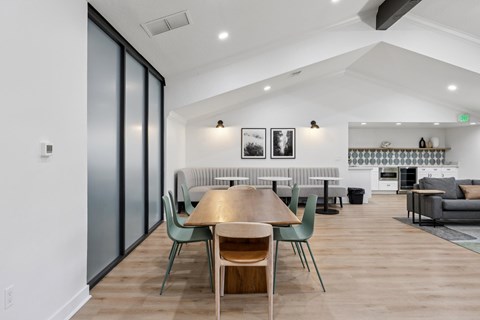 A modern dining room with a wooden table and chairs.
