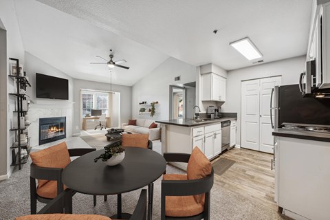 A modern kitchen with a dining table set for four.