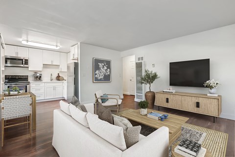 A modern living room with a white sofa and a wooden coffee table.