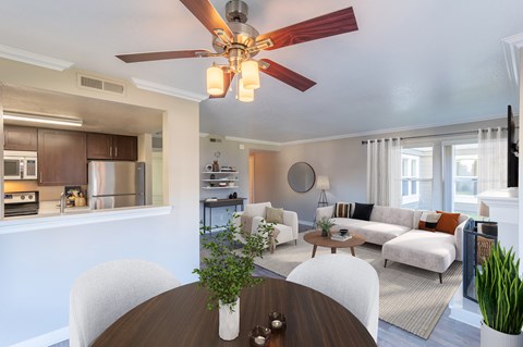 A modern living room with a dining table and chairs.