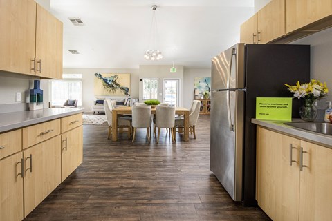 A kitchen with a dining table and chairs in the middle of the room.