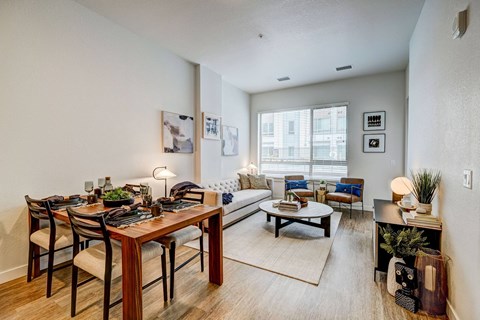 A well-lit living room with a dining table and a couch.