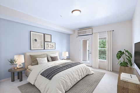 A bedroom with a large bed and a window with curtains.