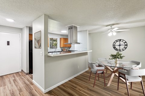 A dining room with a table and chairs.
