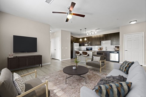 A living room with a grey couch and a brown coffee table.