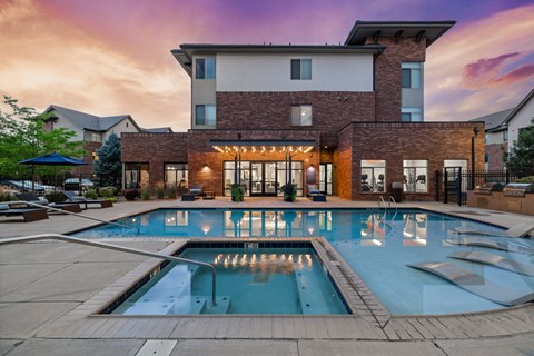 a large swimming pool in front of a building