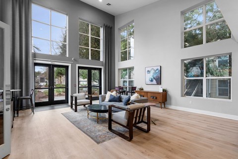 A modern living room with a glass table and chairs.
