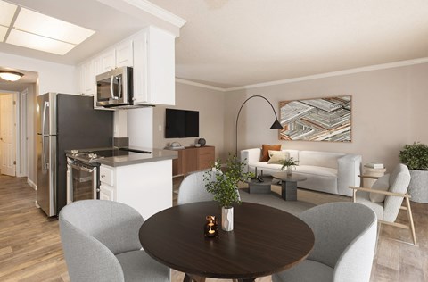 A modern kitchen with a dining table and chairs.