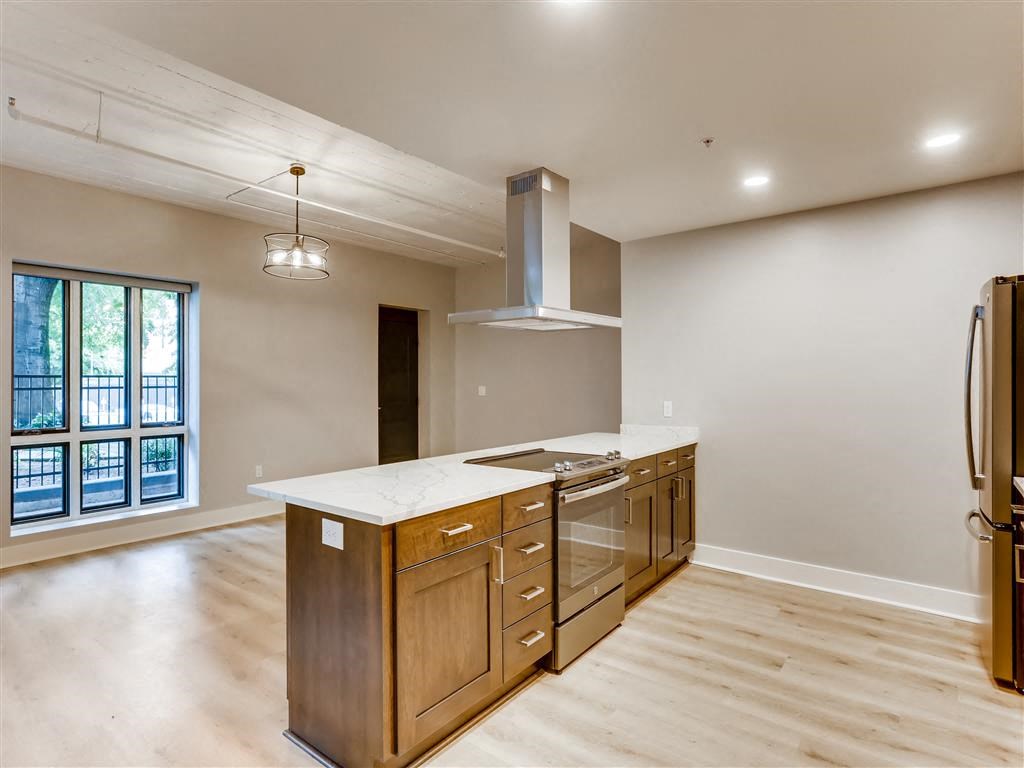 a kitchen with wooden cabinets and a white counter top