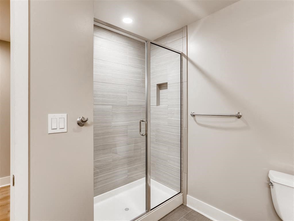 a bathroom with a shower and a toilet