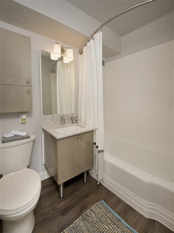 a bathroom with a toilet and a sink and a bath tub