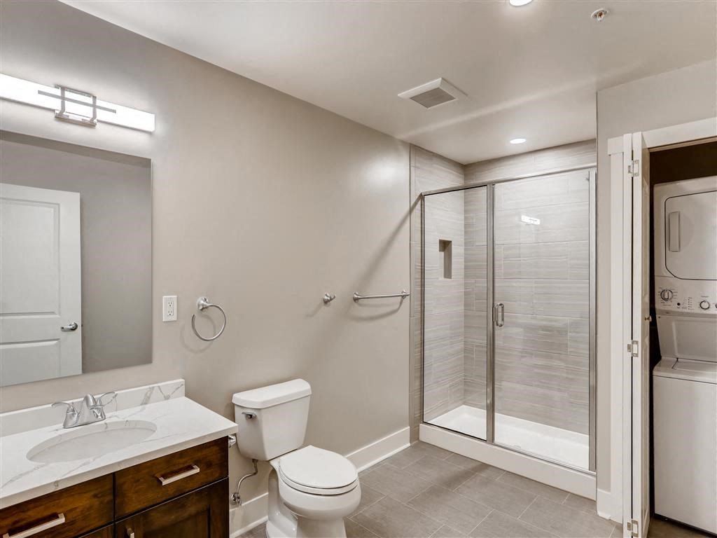 a bathroom with a shower toilet and sink