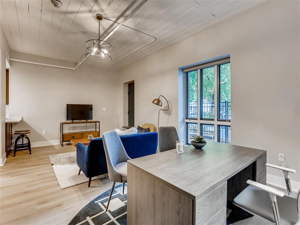 a living room with a couch and a table and a tv