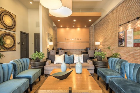 A living room with a blue couch and a wooden coffee table.