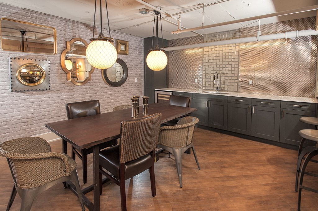 a dining room with a table and chairs and a kitchen