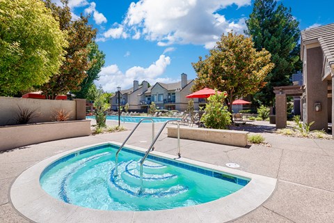 A small round pool with a ladder in the middle.