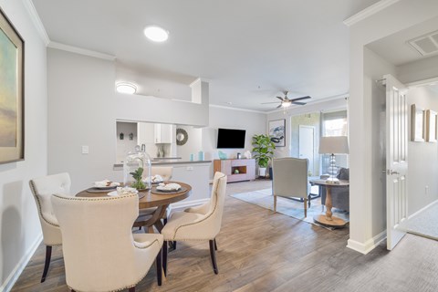 A dining room with a table set for four.