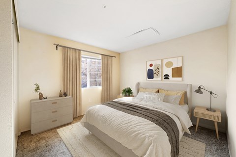 A bedroom with a bed, nightstand, and lamp.